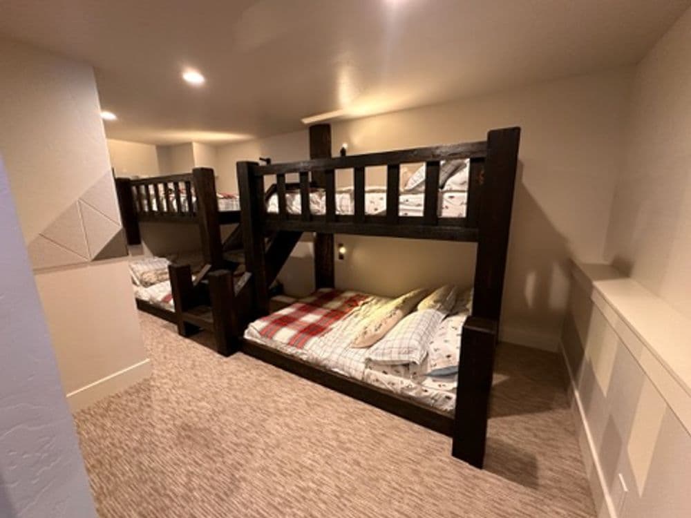 Cozy bunk beds in a well-lit room with soft carpet and neutral walls. Perfect for kids.